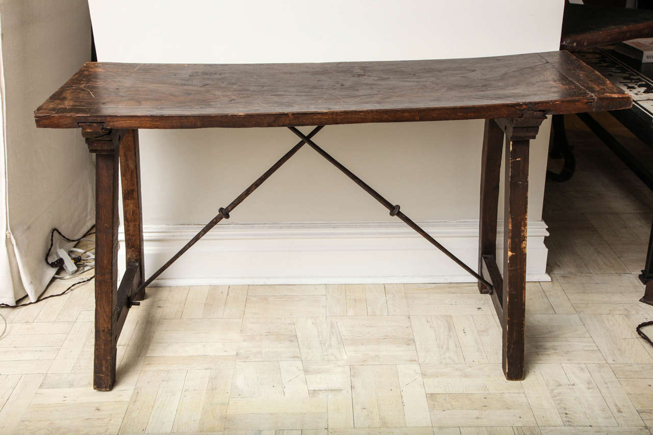 18th century walnut side table, curved iron trestle joined by splayed legs.