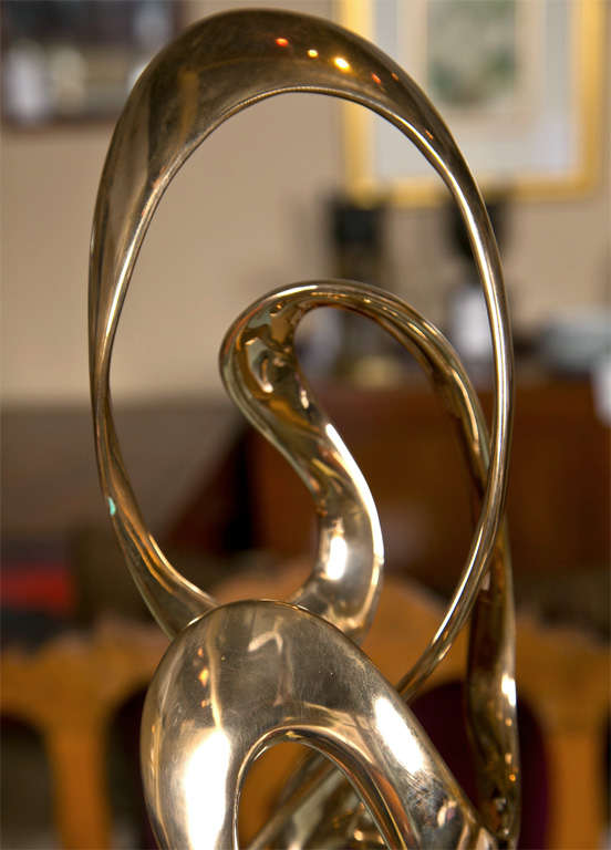 A bronze ribbon form sculpture by Tom Bennett.  Number 75 of 150.