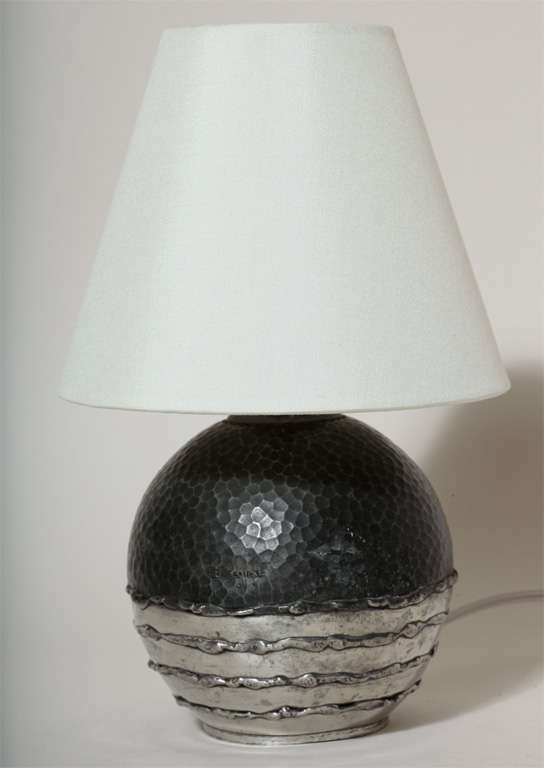 Lamp base is made of black martele´ upper body and polished metal lower body with applied metal horizontal rings by Rene´ Delavan (active 1926-1958). Original French electrical components but rewired to U.S. standards. 
New silk shade.

Overall h: 9