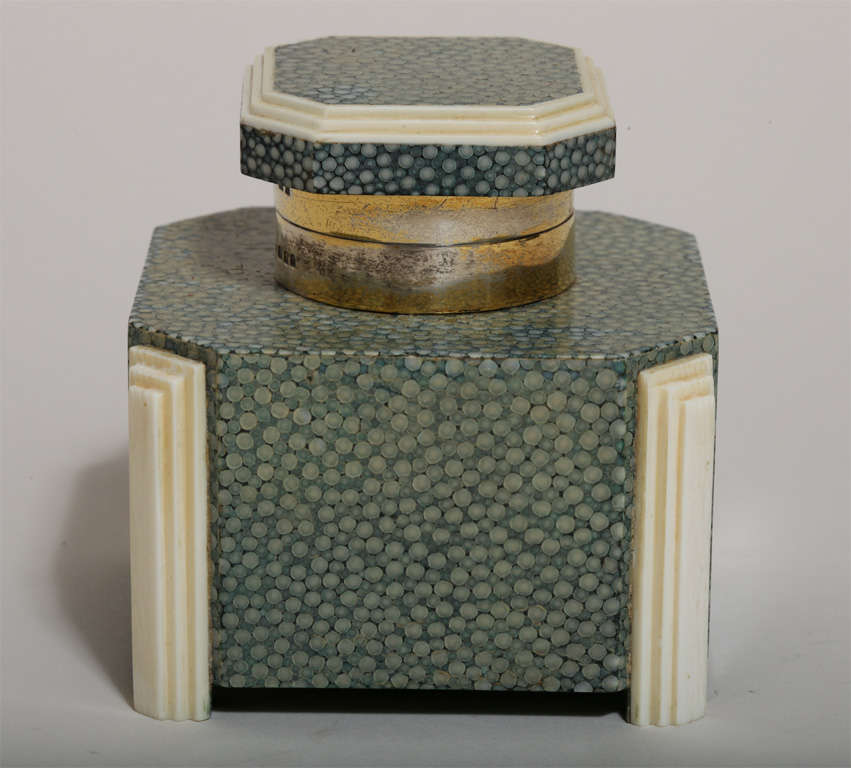 Inkwell covered in green shagreen with stepped bone decoration around the lid and on four corners with silver collar and with glass liner.
Hallmarks:  for 925 silver/ London/ 1931/ G.B.&S

*Variety of other shagreen desk accessories available.