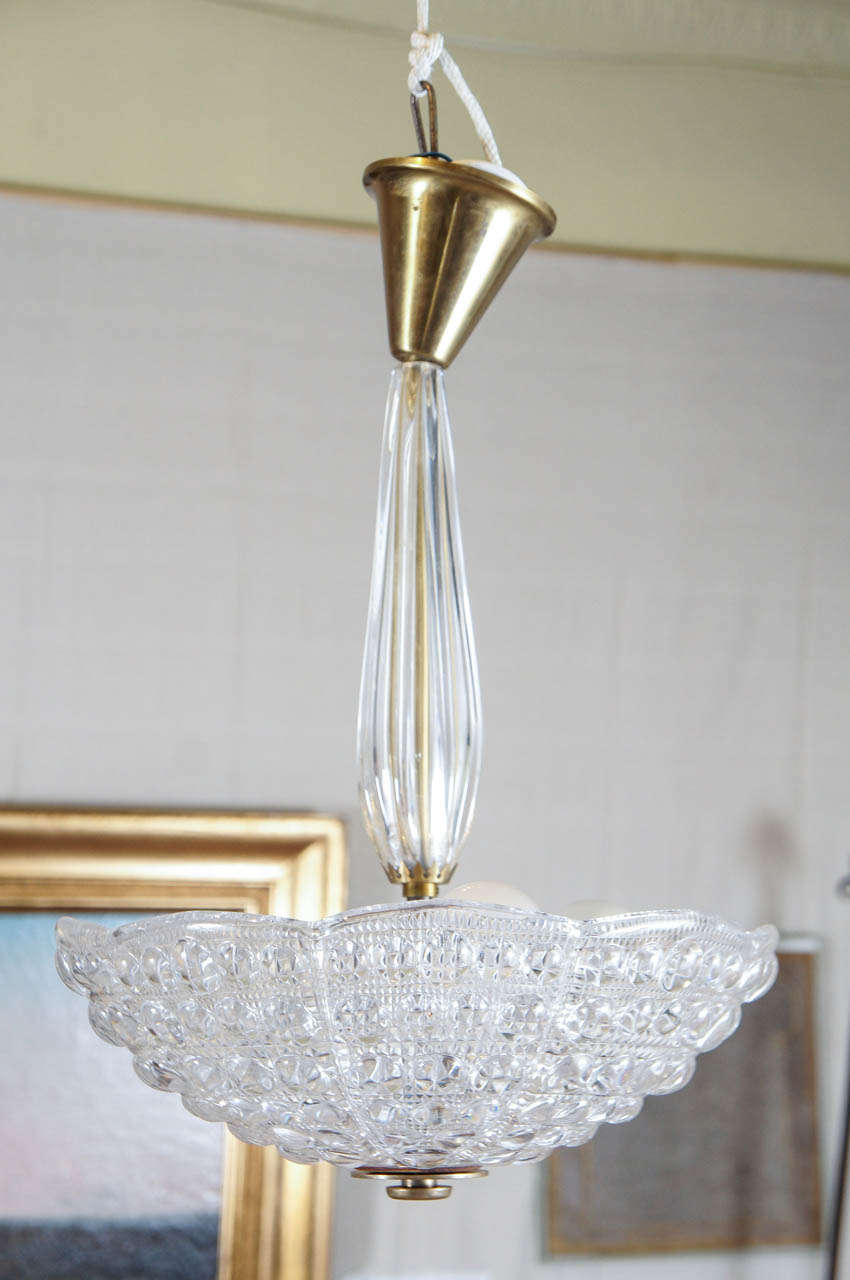 Bowl shaped chandelier by Carl Fagerlund for Orrefors of Sweden, in pressed glass with glass stem and brass fitments.