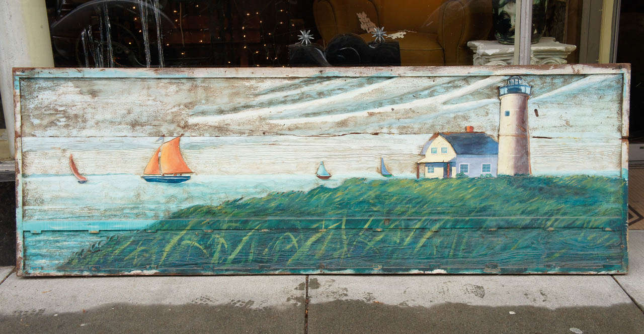Large wood carving featuring a New England scene with yachts and lighthouse, with old paint. Carved from three boards and framed.