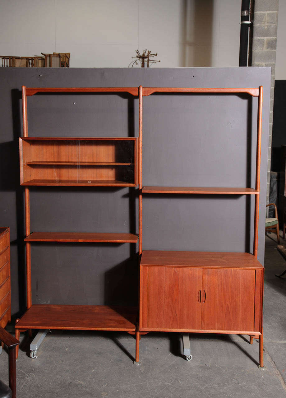 Kurt Ostervig Danish Modern open 2-section Teak Wall System.  Features height adjustable shelves, tambour door cabinet and display cabinet.
