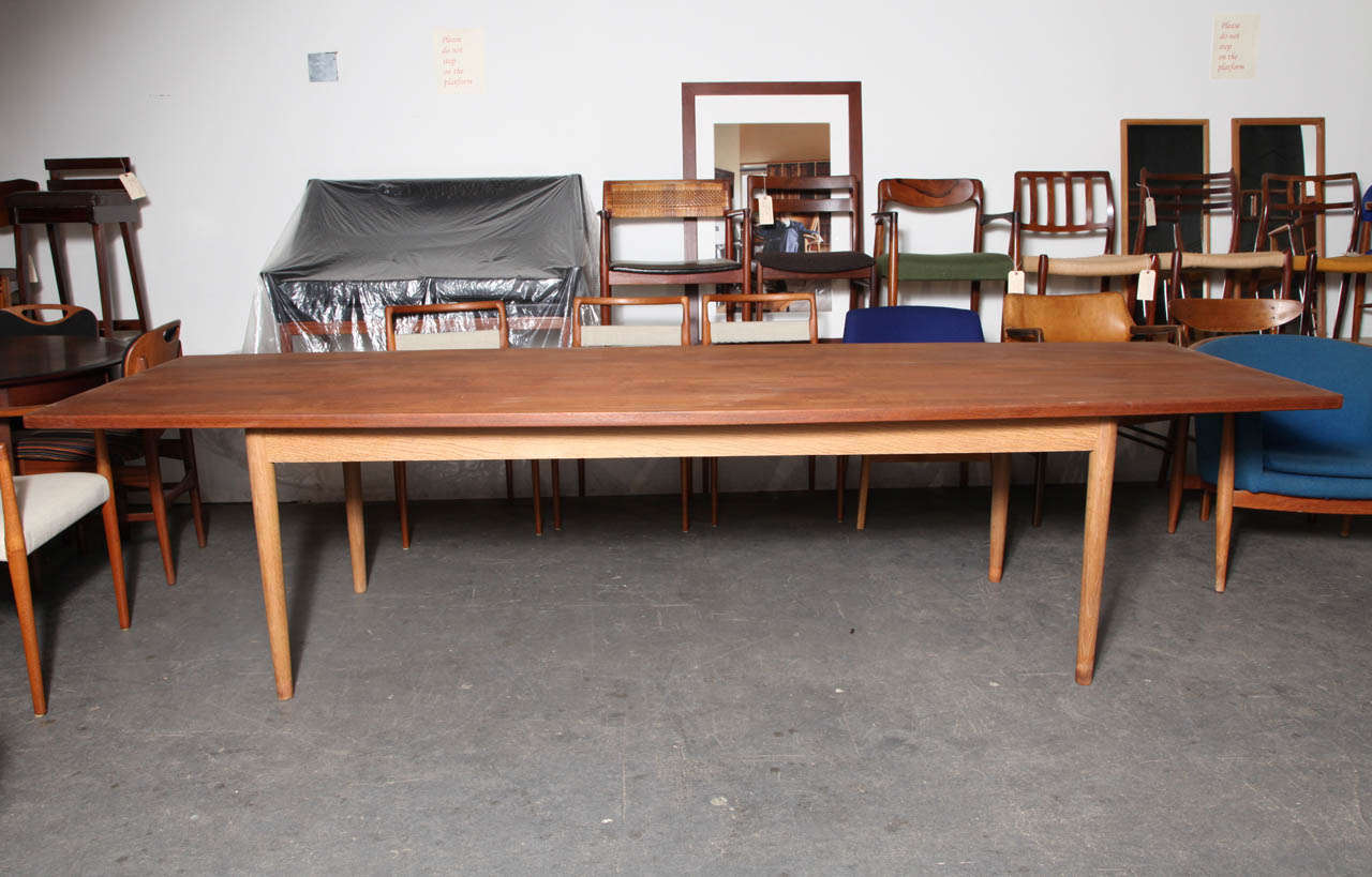 Extra long Danish Modern teak dining conference table.  Features a seamless bowed table top and oak legs.