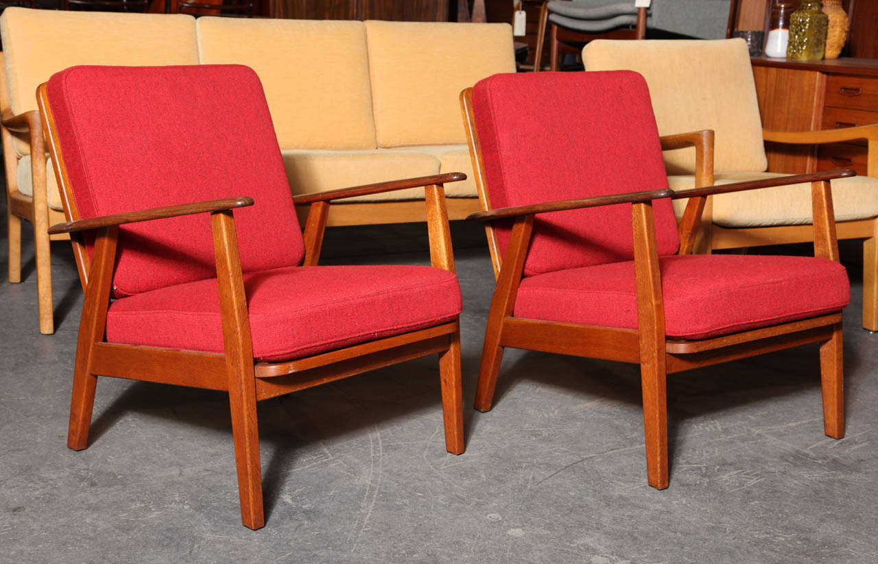 Beautiful pair of Teak Danish Modern Armchairs in excellent condition.  Features a ladder back, spring cushions, and original upholstery.
