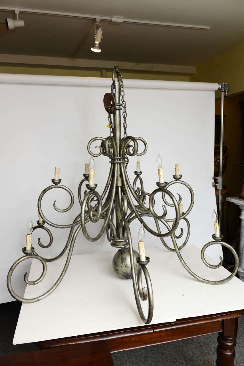 This is a very impressive huge vintage metal chandelier in perfect working order.
It has 12 candle light holders, to the base there is a round ball which comes of for transport.
Not sure of the maker its almost like a holly hunt