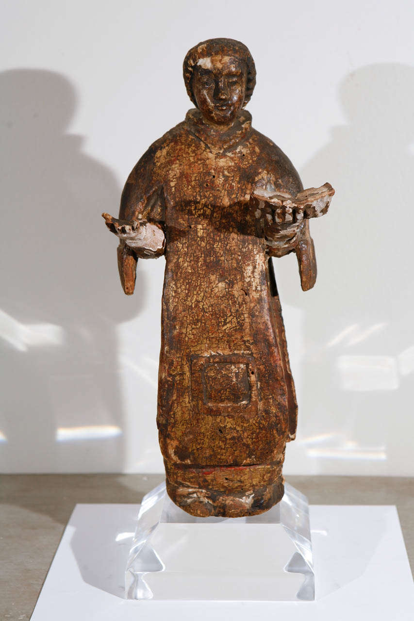 This an antique carving of a saint from Italy. It is carved and gold gilded wood with age appropriate wear. It comes with a custom acrylic base.