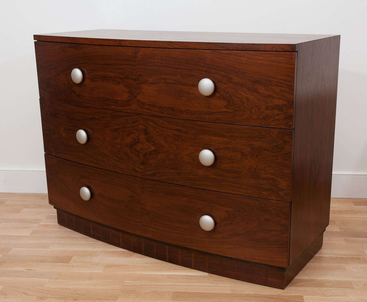 A sumptuous pair of rosewood veneer Art Deco chests designed by French designer Gilbert Rohde for the Herman Miller Company. Restored and refinished with contemporary hardware.