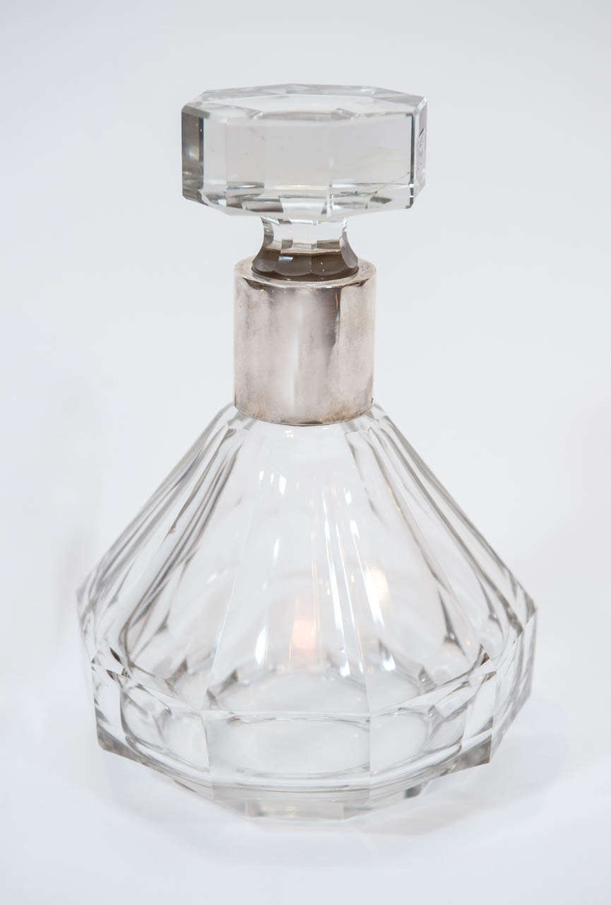 An Art Deco decanter of exceptional
quality with sterling detail attributed to
French crystal manufacturer Baccarat.