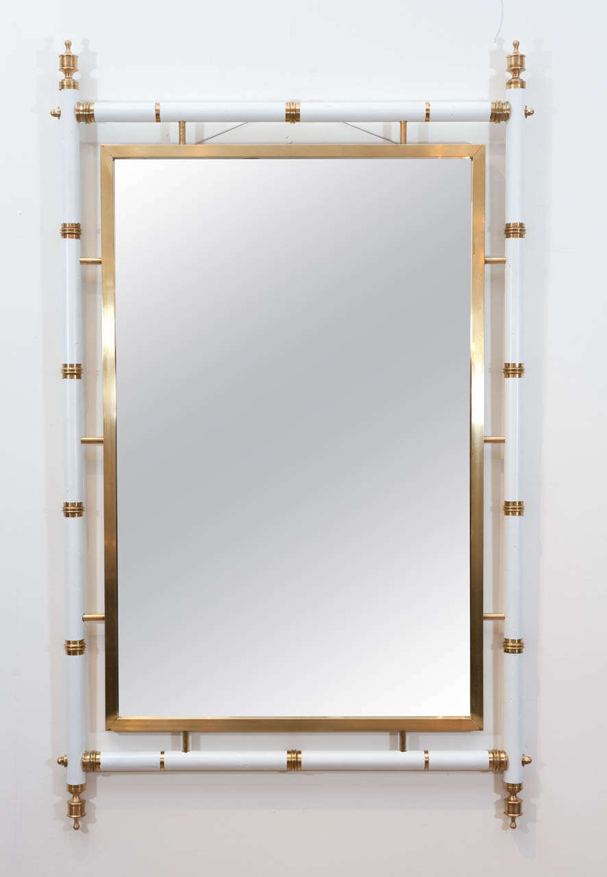 This stately white faux bamboo mirror with exceptional polished brass details is as glamorous as it is understated.