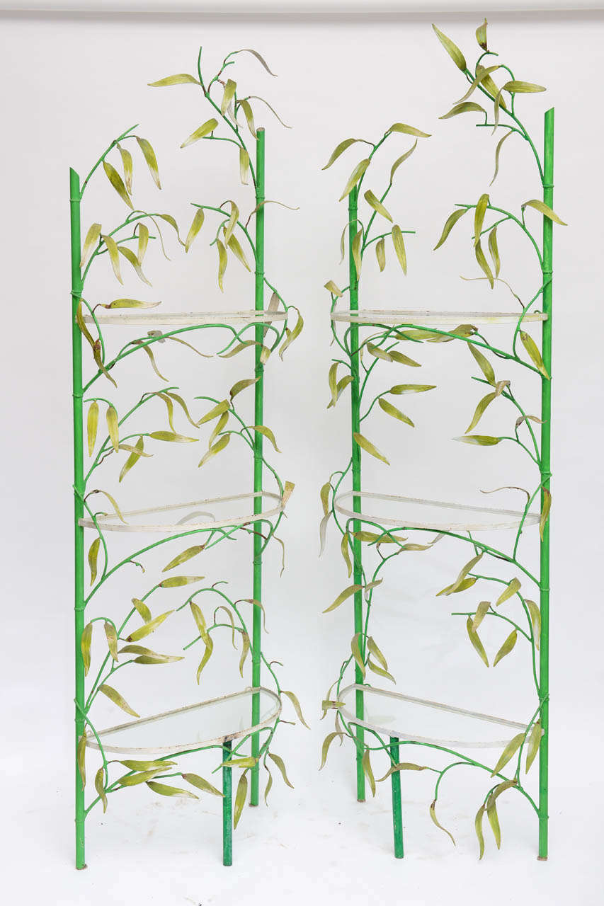 Whimsical pair of iron shelves with green painted 'bamboo' motif. Three glass semi-circle shelves for each unit included.