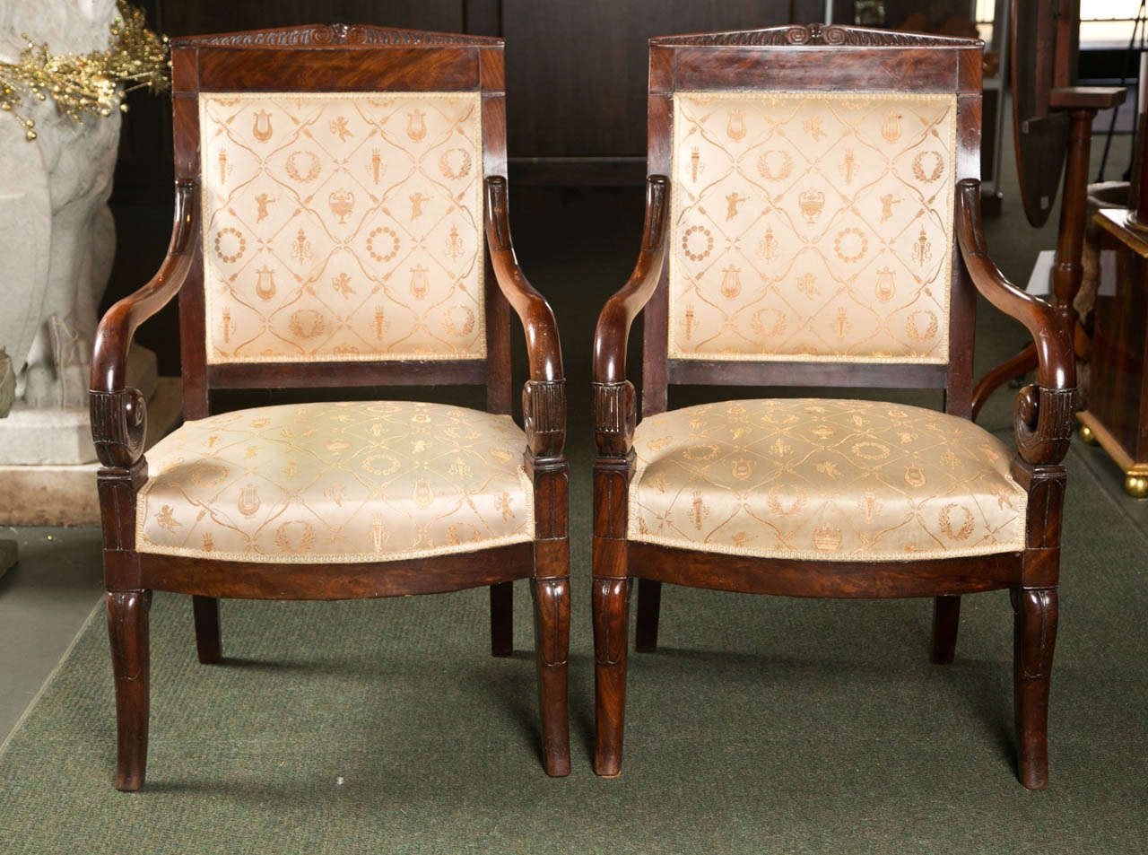 A magnificent pair of Charles X mahogany nicely carved fauteuils with great upholstery.