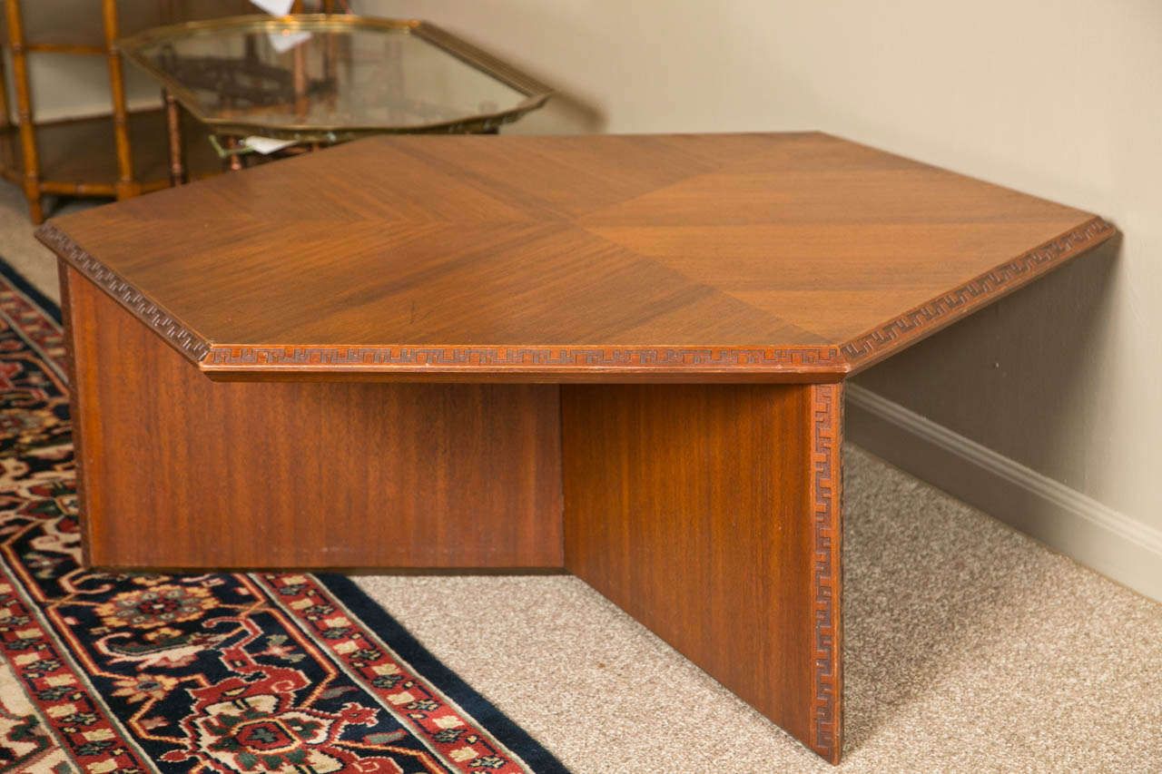 A hexagonal mahogany coffee table by Frank Lloyd Wright. Signed.