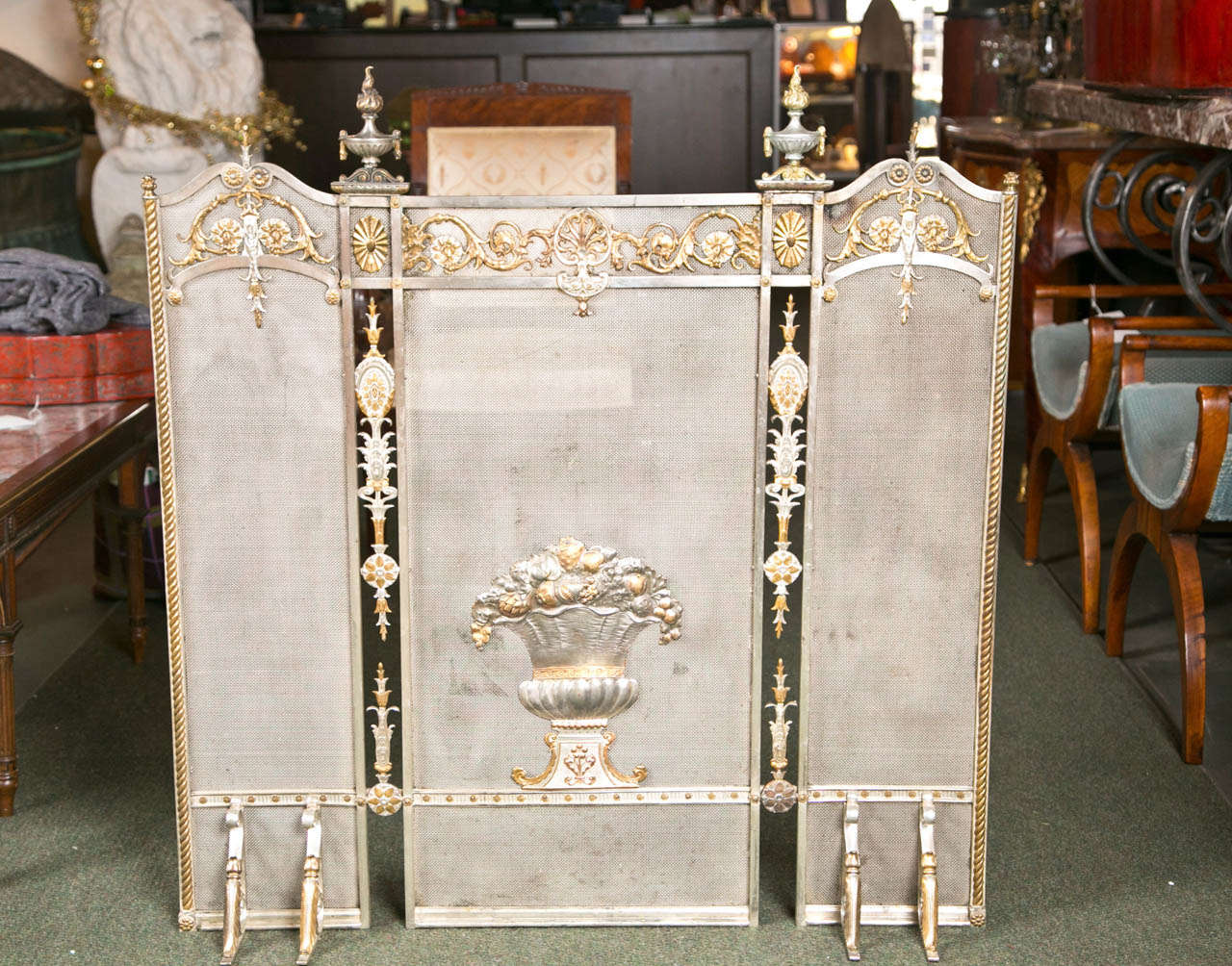 A fabulous silver and dore bronze Edwardian firescreen in the classical manner.