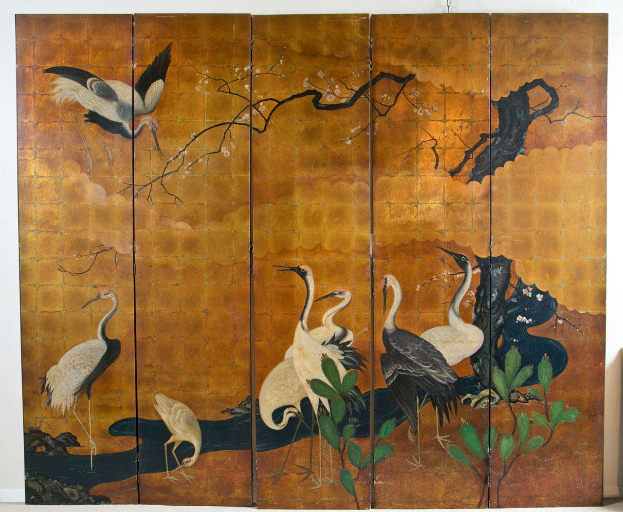 A stunning hand painted Japanese screen with five panels depicting images of cranes.