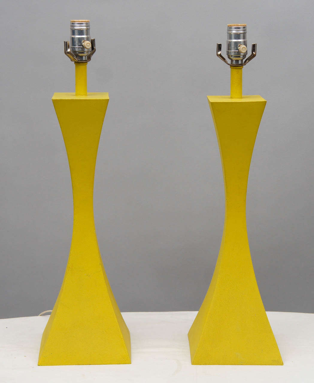 Two cast-metal table lamps in a parabolic shape, coated in its original vivid 1960s chartreuse enamel.