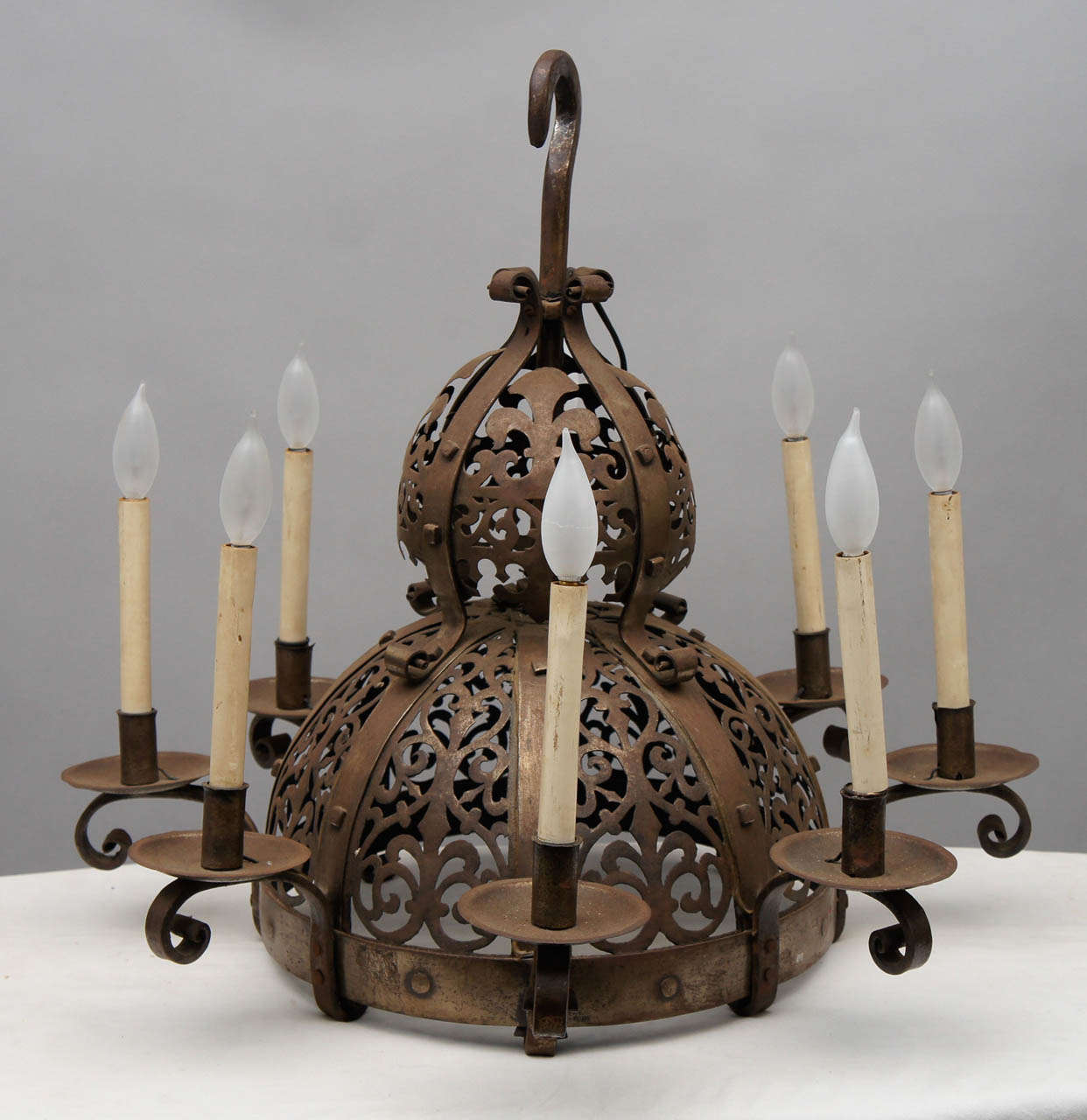 Moorish style metal light fixture with ornate calligraphic design.