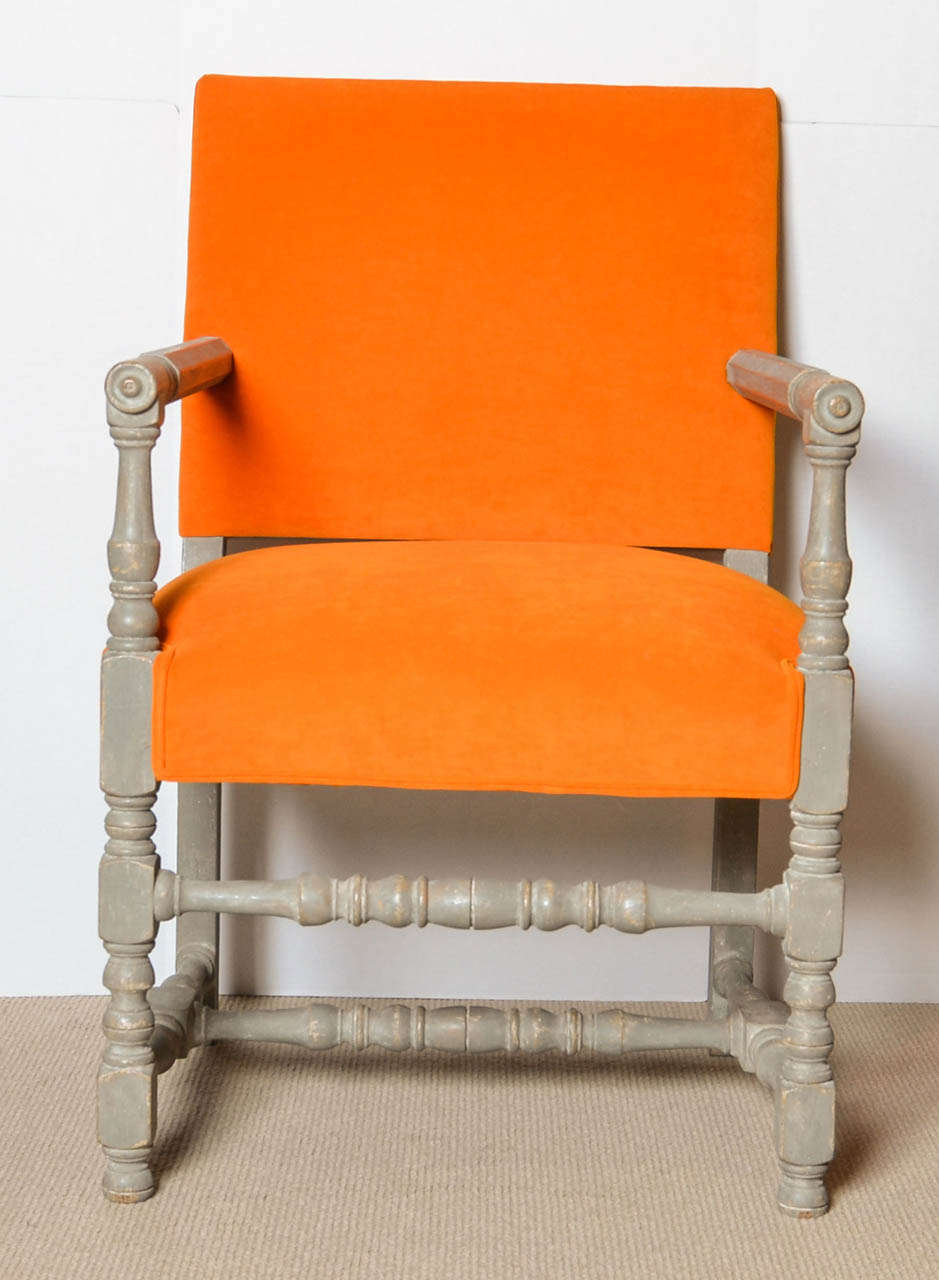 Upholstered orange arm chair.