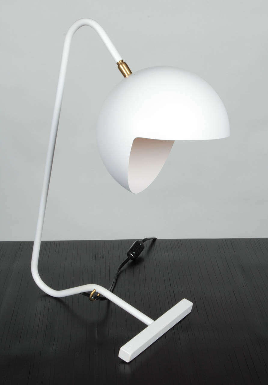 Made of hand-molded metal the timeless Pacman fixture is now in white with a simple slim white stem and base for support complete with a rotating head and bulb. Available to order in black or white exterior with gold, white or silver interior