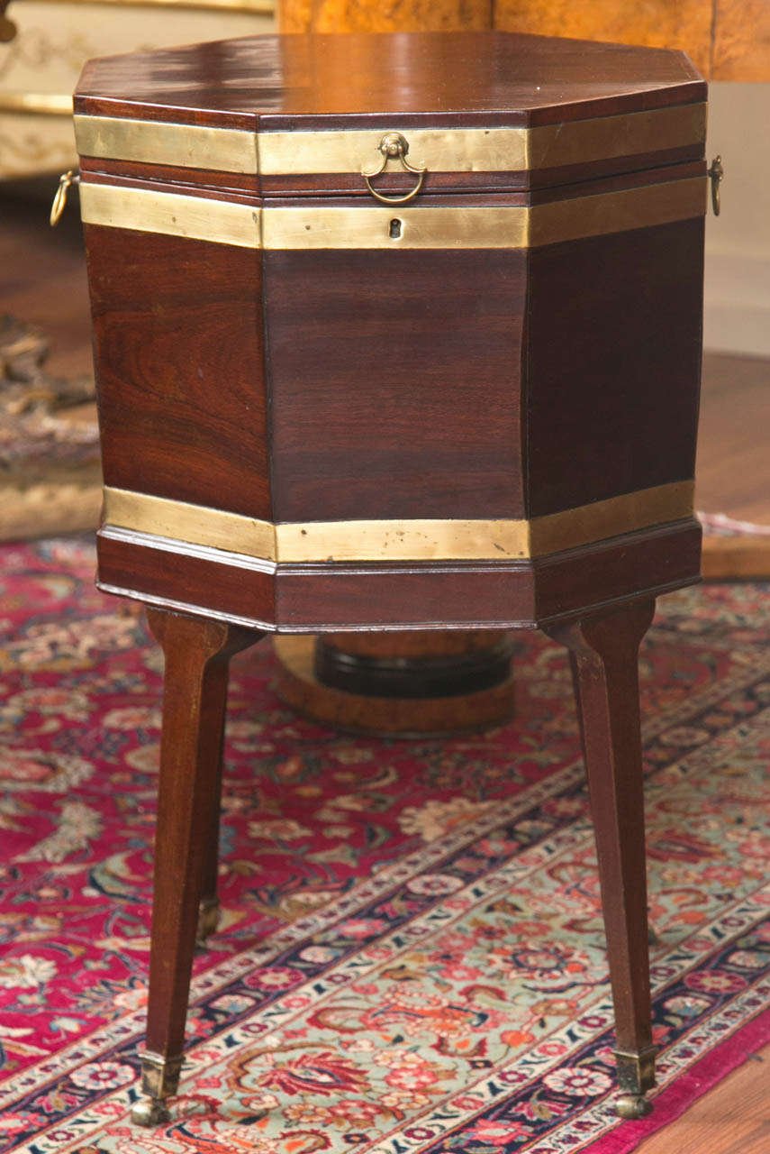 A Fine Quality English George III period neoclassical mahogany and brass bound wine cooler on square tapering legs ending in brass casters, the base with original sprout. Circa 1770