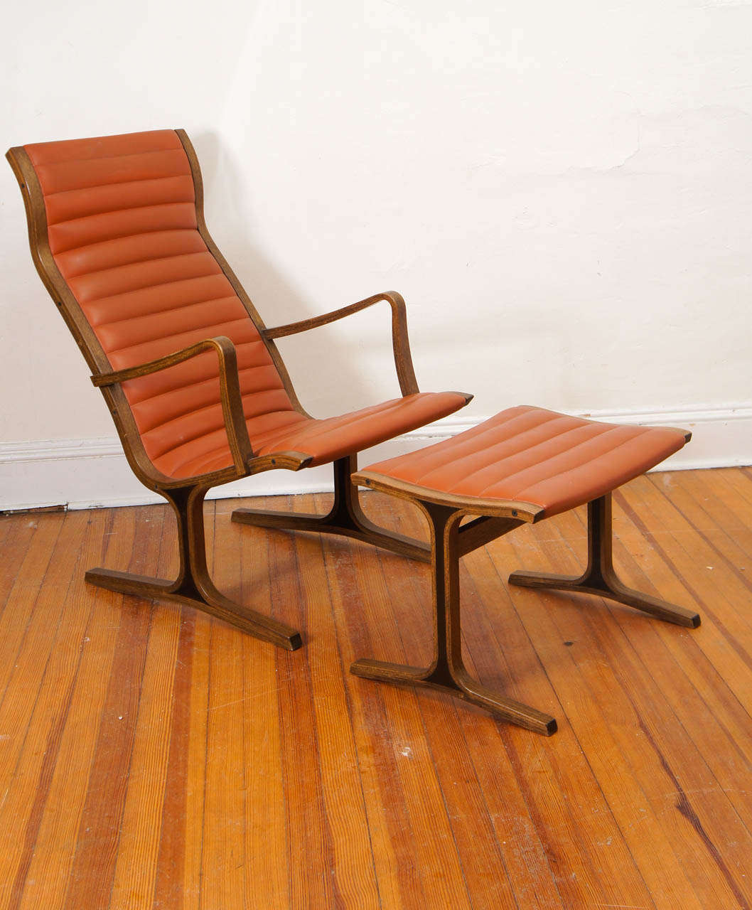 A Kosuga chair and ottoman in walnut in original orange Naugahyde.
Great set for that Dwell type minimalist.
In great condition with light ware.