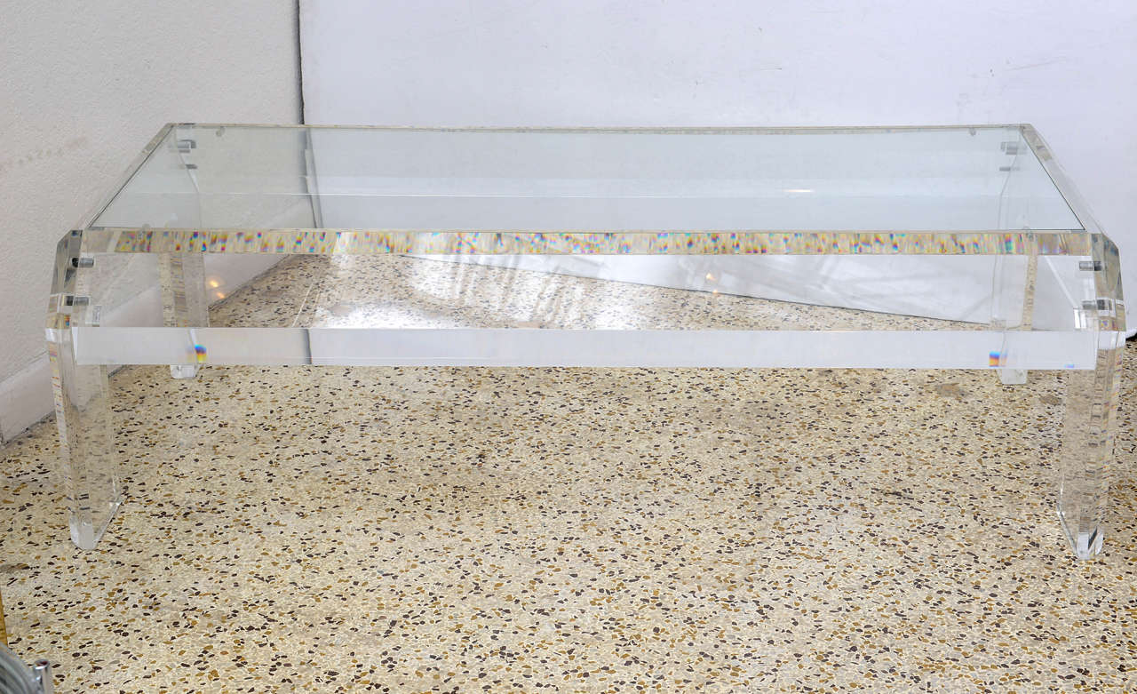 Vintage rectangular coffee or cocktail table.  Thick lucite frame and legs with a glass top insert.  Glass alone measures 48