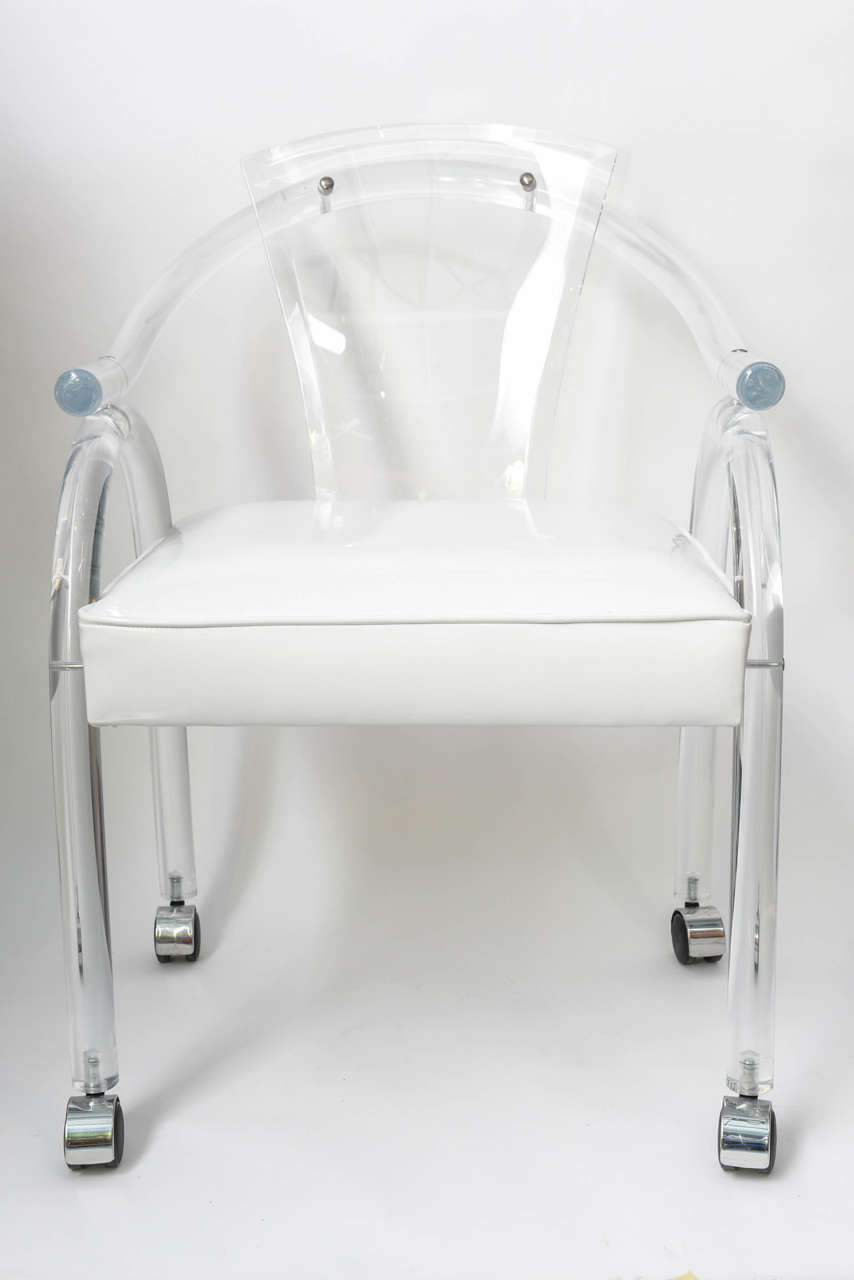 Always be fabulous with these 4 Lucite chairs.  With a nod to Charles Hollis Jones' work, the curved Lucite and freshly restored white vinyl seats make for a fresh, modern take around any table.  Perfect for a dining area even for an office, these
