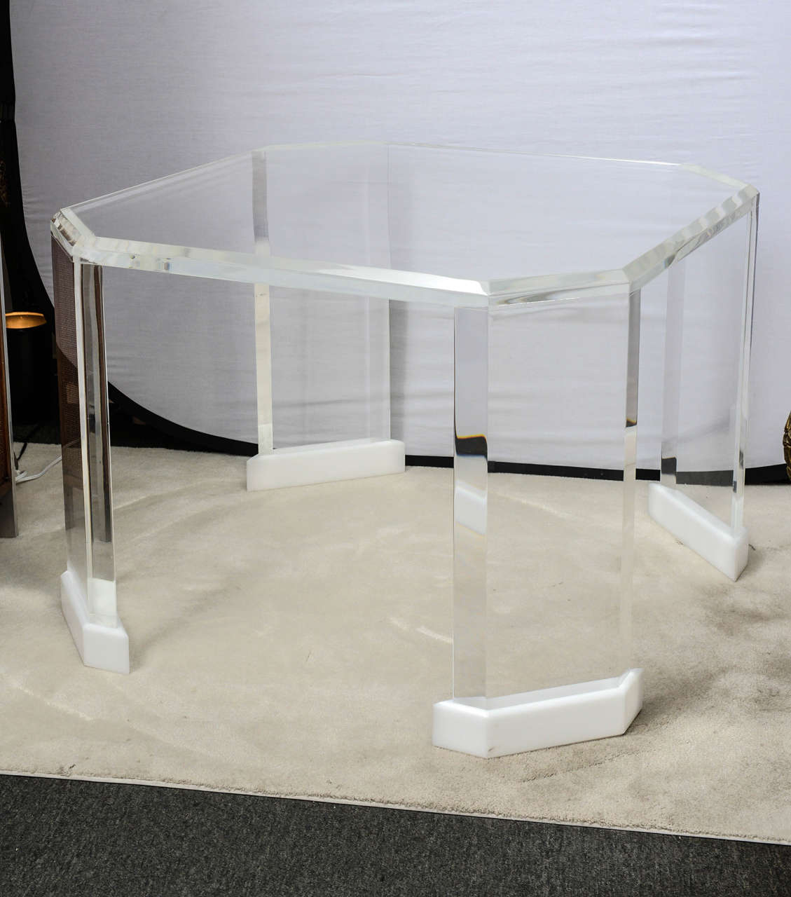 Solid yet ethereal, this marvelous table both grounds a room yet does not dominate it.  With a shape and style much like the designs of Charles Hollis Jones, this table could be used formally or informally.  The table leg bases are kept fresh and