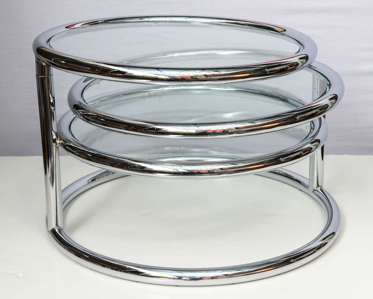 Options never cease with this wonderful coffee table. Three tiers of polished chrome tubular framed and glass easily fold and open to your need and pleasure. It can be used as a side table as a coffee table when is totally open and works well with