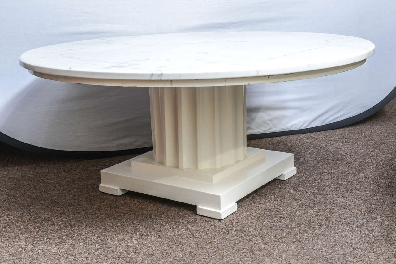 Classical features in spades is what this table offers.  Beautiful Italian white and grey marble tabletop in perfect condition.  Base made in wood is reminiscent of a Greek column. Slight scratches on the sides underneath the marble top. The base