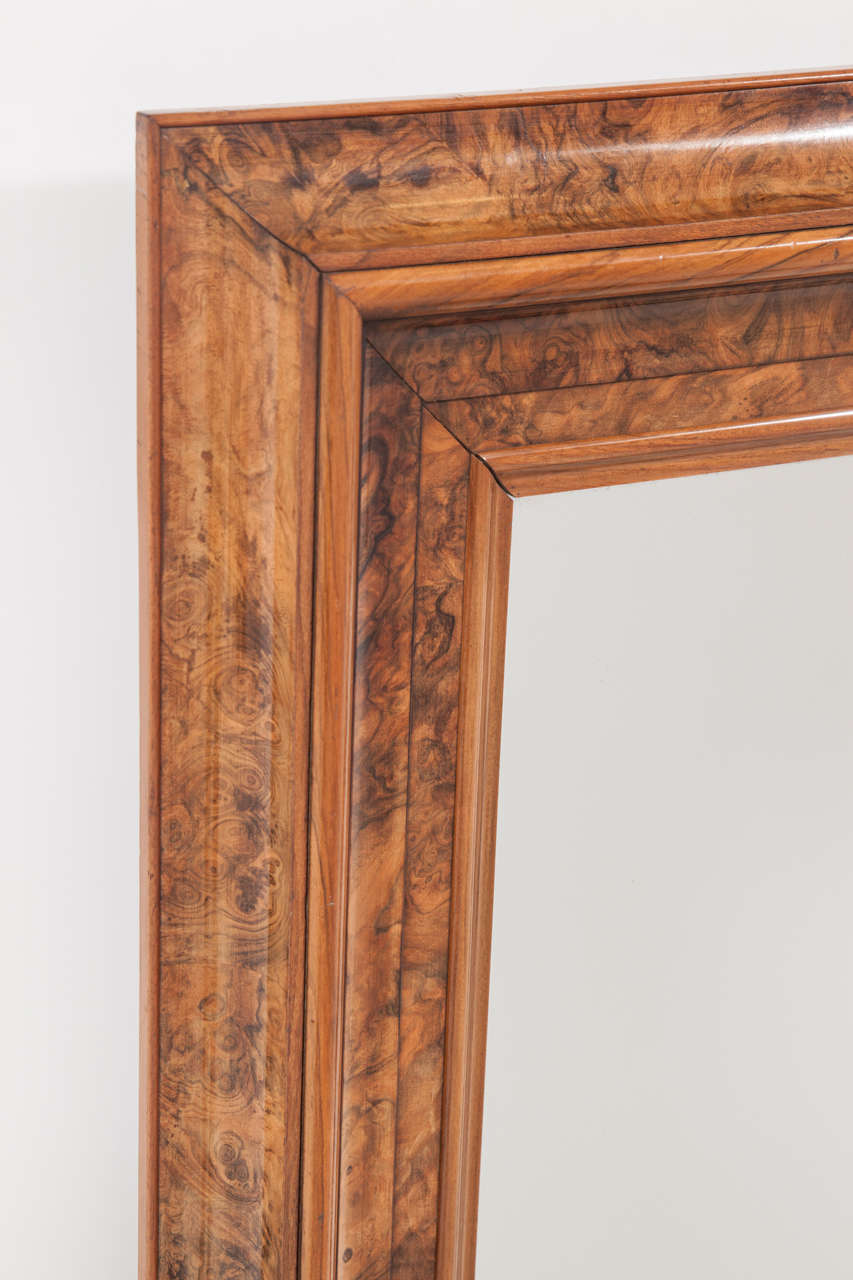 A pair of Danish highly figured burl walnut mirrors, with a wide flat and cove frame and original glass.

Both mirrors stamped with the crest of King Frederik VII (1848-1863)  Christians Castle, Copenhagen  and inventory number. The last stamp
