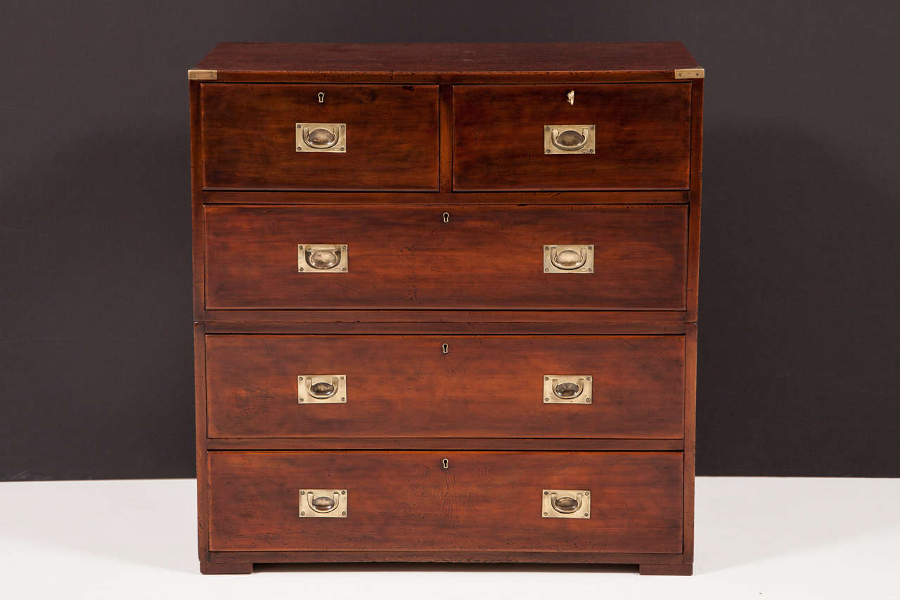 An English brass-mounted mahogany Campaign chest of drawers, late 19th century, in two parts with two short drawers over three long drawers.