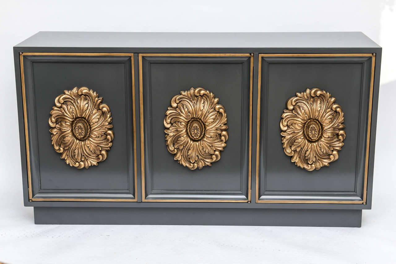 Dorothy Draper style, Hollywood Regency era Lane Altavista media cabinet or credenza on a raised platform with three recessed door fronts and hidden brass hinges. Newly refinished in a high gloss, charcoal gray color with hand-painted gold trim