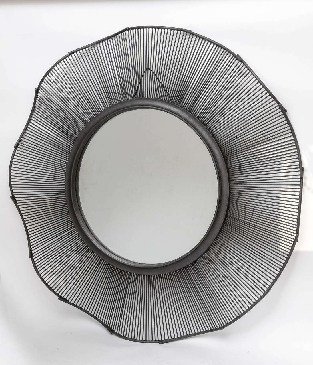 Hand-forged oversized iron center hall or entry hall mirror, in an undulating and wavy pattern, capped with a thick, interior forged surround, and an outer Brutalist style.