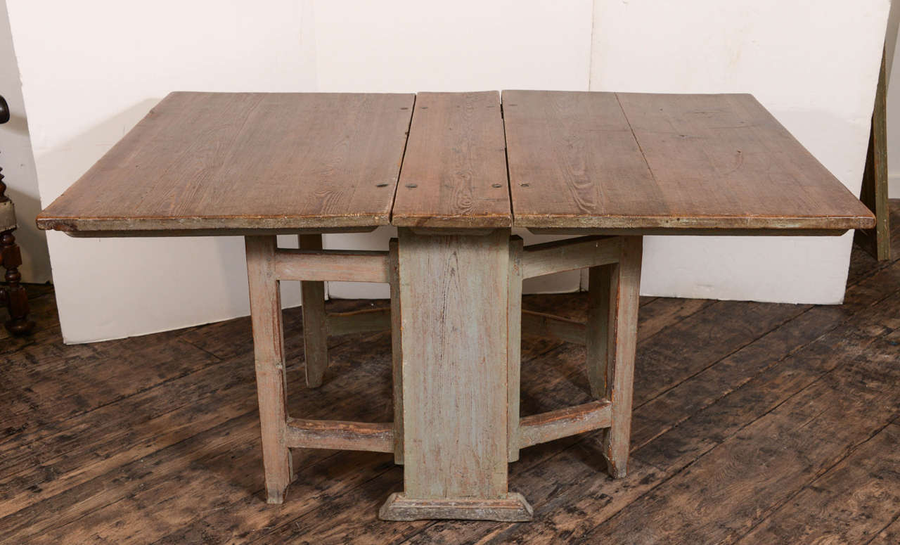 Charming Swedish drop-leaf table from the 19th century, base has scraped finish to show the original paint.
