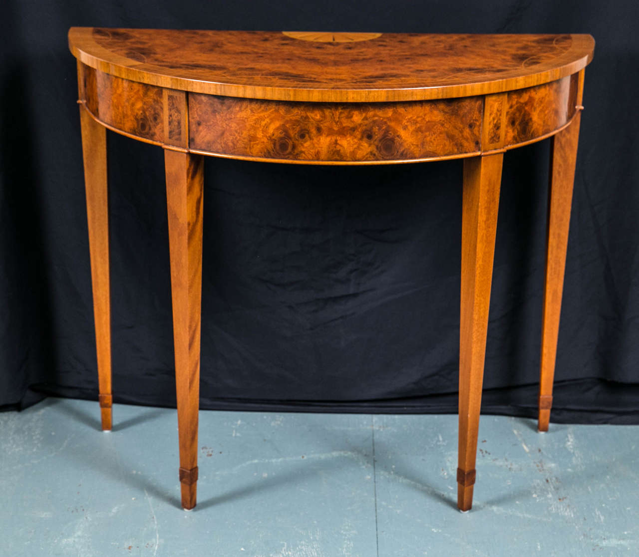 Custom made for us in England by our talented craftsmen this table features a segmented, bookmatched top with boxwood inlays, a deep apron and tapered legs. A classic look that offers myriad options for use as side table that will blend with just