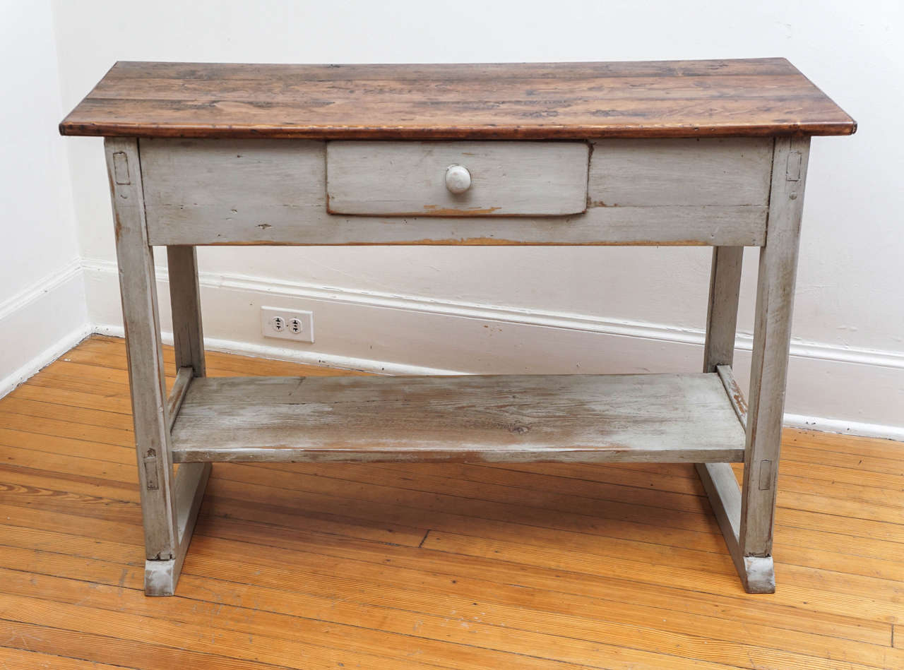 We love Irish pieces at painted porch and love pot board shelves with our tables. It adds both character and usefulness. This is painted grey with a dark pine top and one drawer.