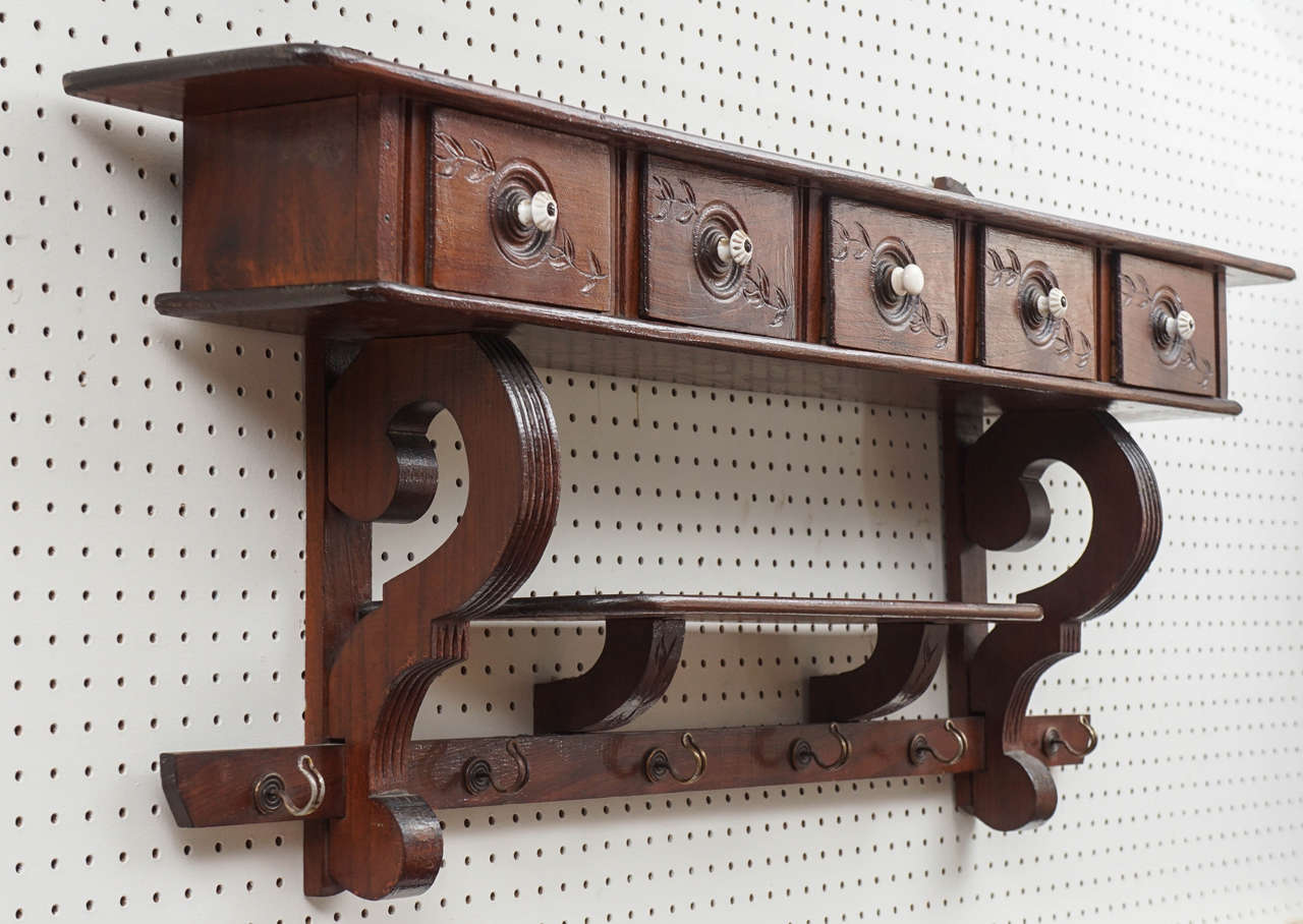 This shelf is loaded with options. Not only are their two shelves but there are five spice drawers with original hardware handles and original hooks how nice would this look in your country kitchen. It could also be used in a mud room. Hang your
