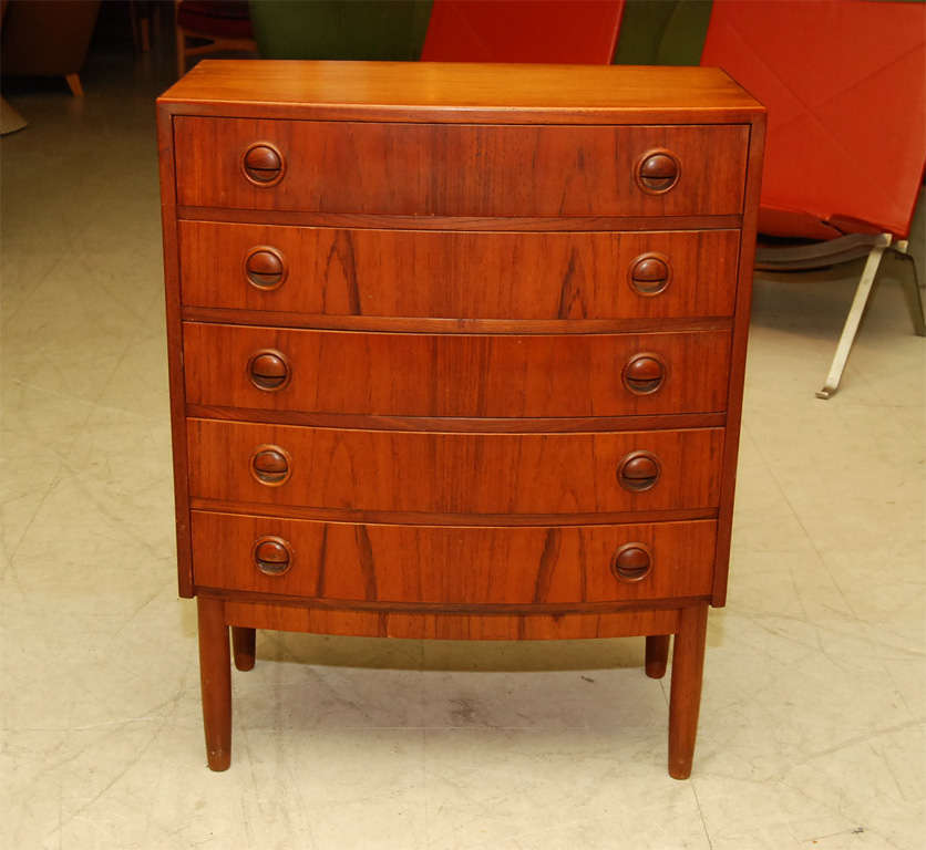 Small sized bowfront  chest of drawers, in rosewood, Danish mid-century modern, with nicely detailed handles and 5 drawers.