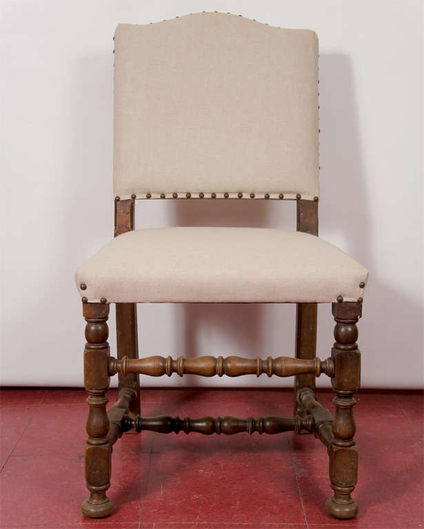 Six Jacobean-style dining chairs beautifully restored and upholstered in natural  linen fabric and brass nail heads.  Turned legs and stretchers.