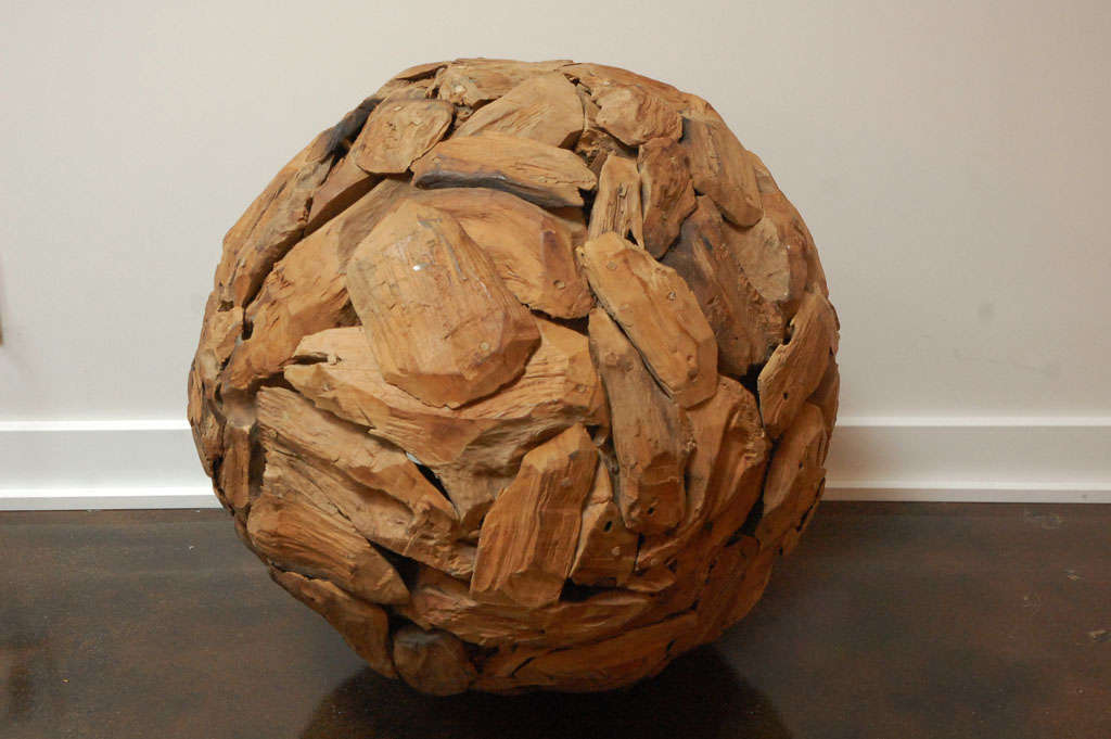 Interesting large sphere sculpture made of many pieces of wood, nailed together. 