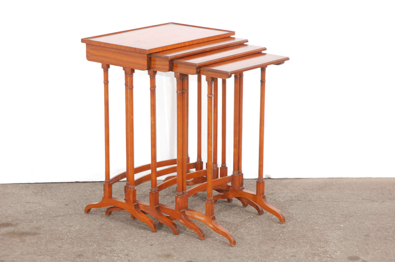 A set of vintage English nesting tables with satin wood tops and maple bases. Each of the tables slide into larger one.

Largest measures 20