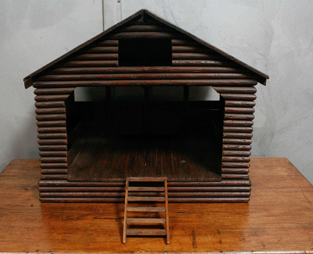 This is a sweet little horse stable model made with precious details. There is a mounted feeding trough below a red glass window at the side, a horse ladder at the front, and windows at the back at the height of a proportioned group of horses to