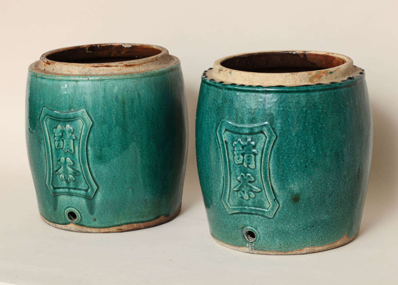 Each of drum-form and molded with calligraphy in a cartouche with a spigot hole.

Provenance:
Collection of Honorable Clare Booth Luce

(Price shown is reduced price, no further trade discount)