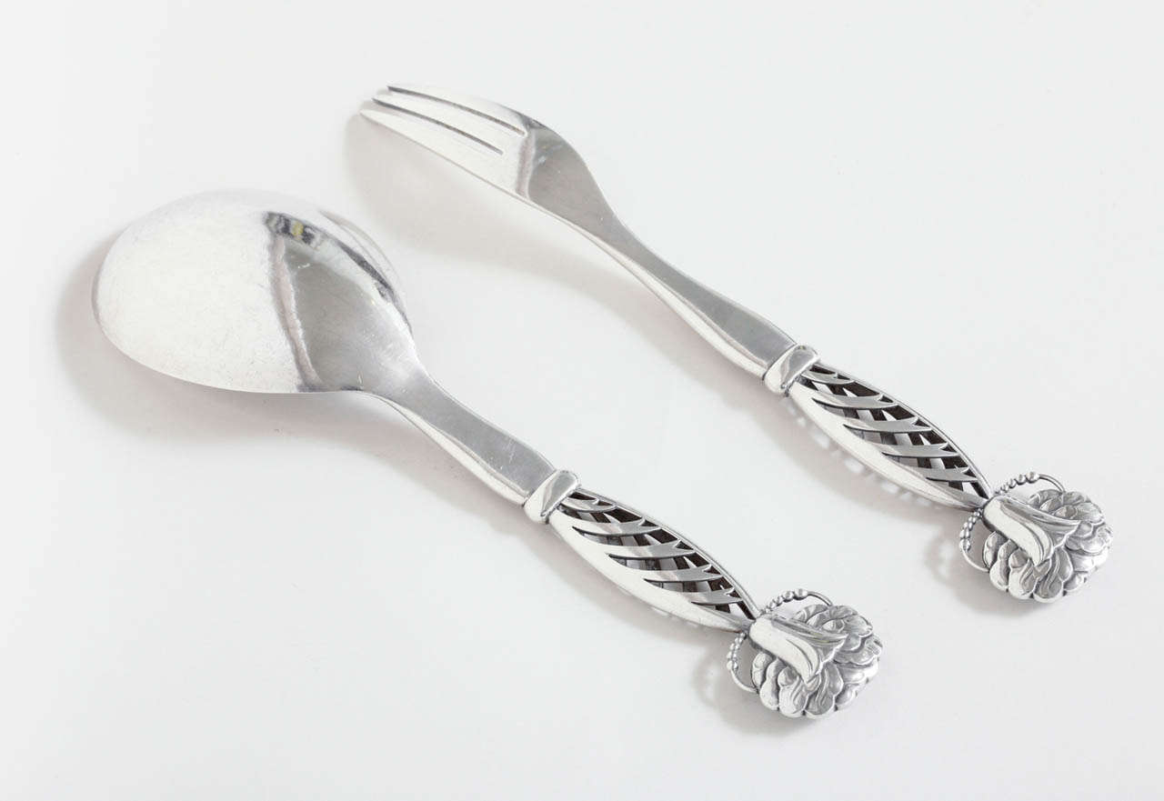 A pair of sterling silver fork and spoon servers designed by Georg Jensen (1866-1935) in 1914 with openwork handles. This set was made during the best period for Jensen silver.
Hallmarks: 925 silver/ 83/ GI (Jensen mark for 1919-1927/ Importe de