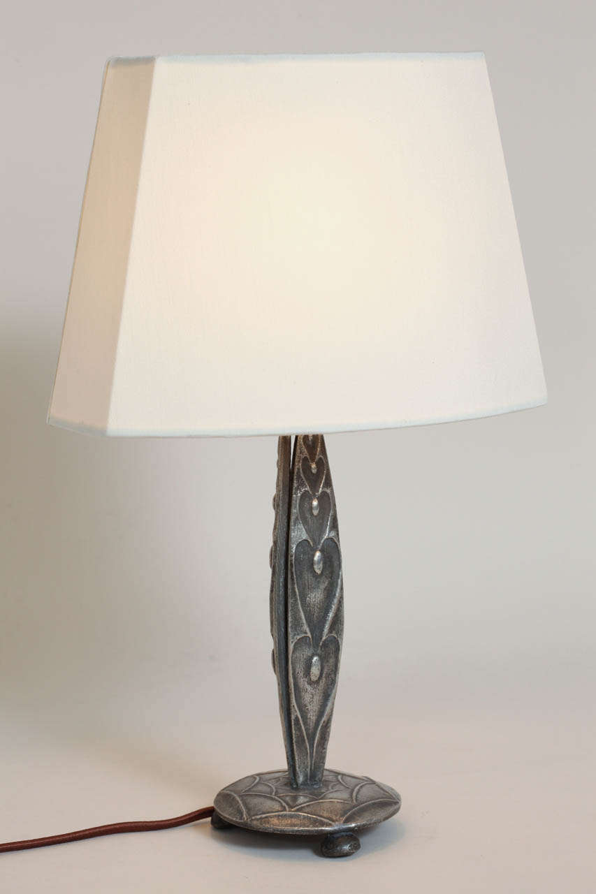 Triangular pewter shaft with geometric design on circular base.  Original French socket rewired for American standard with new silk shade.

Dimensions:
Overall height: 14 5/8