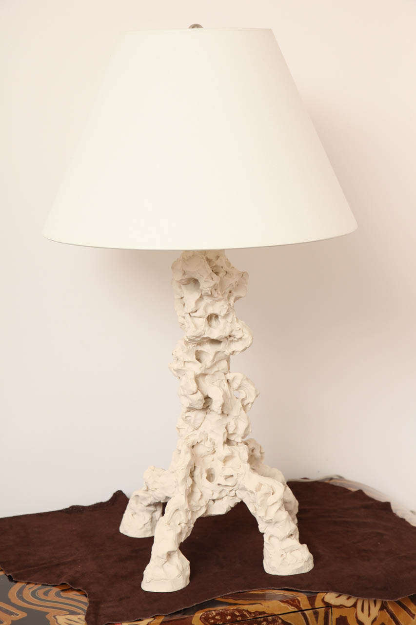 Table lamp inspired by Chinese philosopher's stones. The artist sculpts then casts the lamp base in plaster resin with a hand-applied plaster finish. Raised on four sculpted legs. Lampshade not included.
Made to order expressly by Elliott Levine for