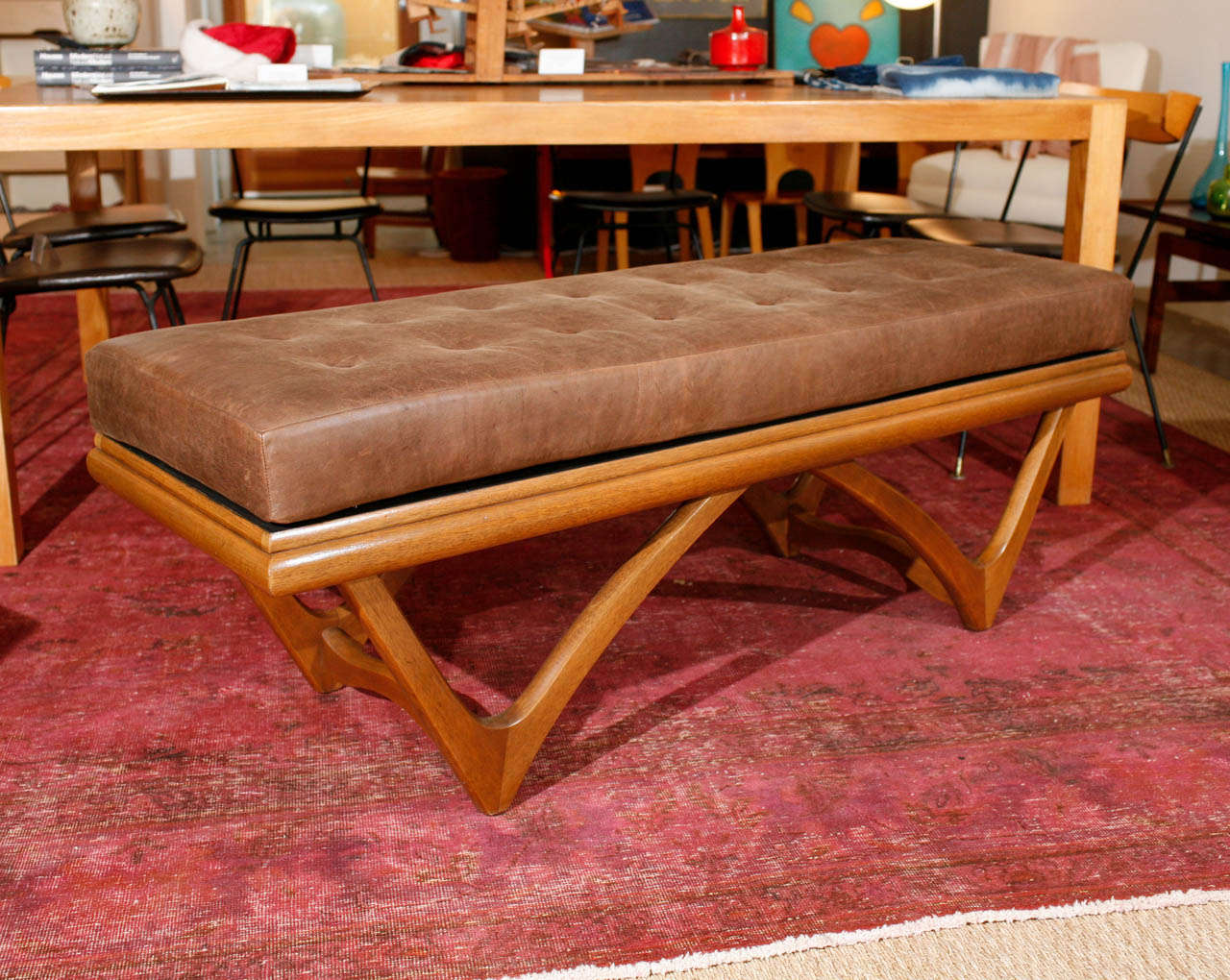 The tufted leather on this vintage Adrian Pearsall bow tie bench is perfectly aged and worn into a soft, beautiful texture. The color is a fawn-brown, which contrasts wonderfully with the honey finish of the maple bow tie frame. This is an