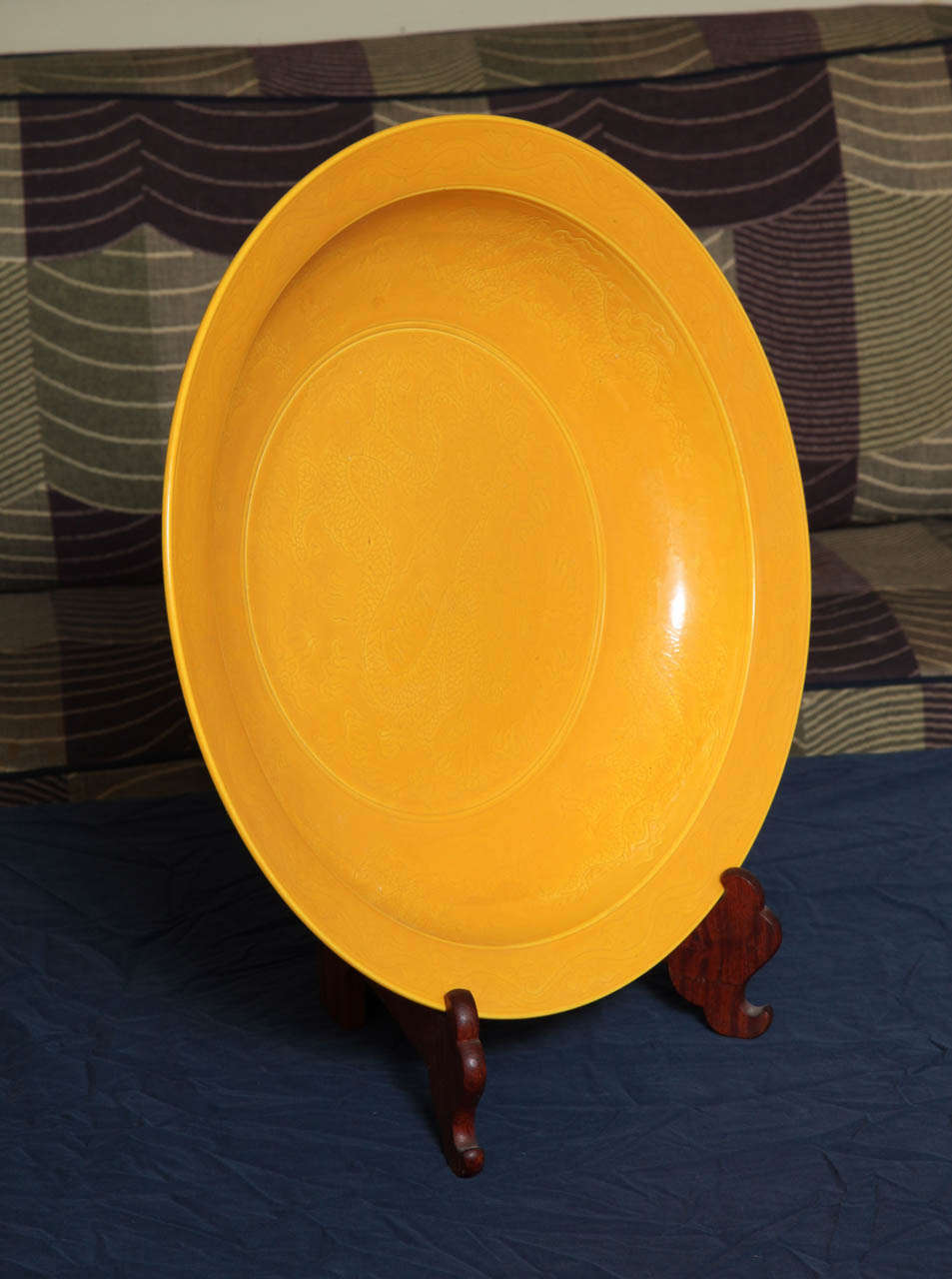 A striking Chinese incised platter in imperial yellow color