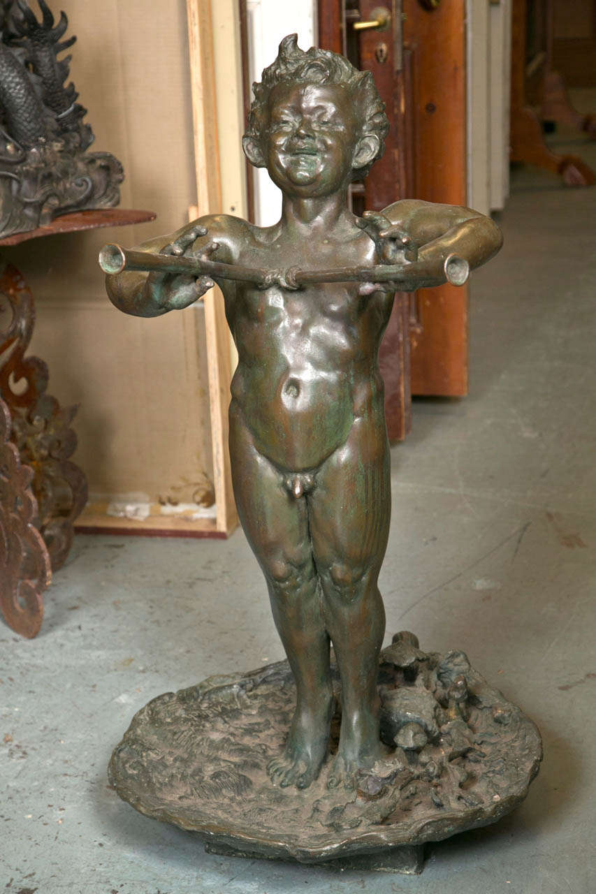 Signed by M.A. Aldrich. This statue of a bronze young man is standing in a lily pad with wildlife surrounding his feet. A turtle and other water creatures  can be seen on pad.
It is truly an incredible piece.  Lily pad is 23